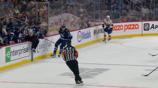 Adam Lowry gets a stick from the bench